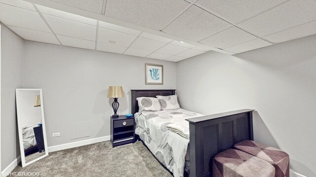 bedroom with a paneled ceiling and carpet