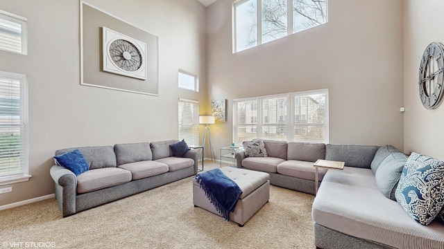 carpeted living room with a towering ceiling