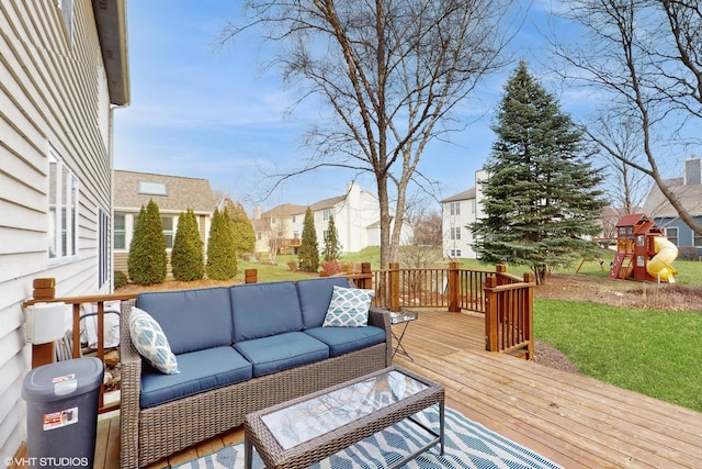 wooden deck featuring a playground, outdoor lounge area, and a yard