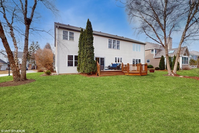 rear view of house with a yard and a wooden deck