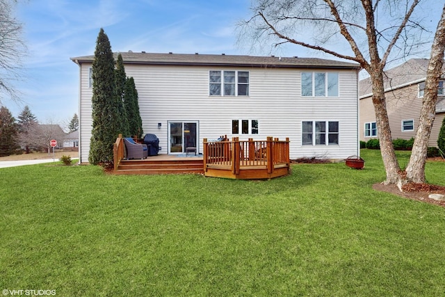 back of property featuring a lawn and a deck