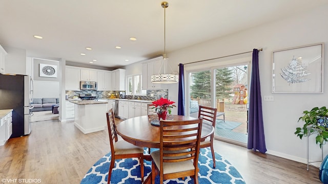 dining space with light wood-type flooring