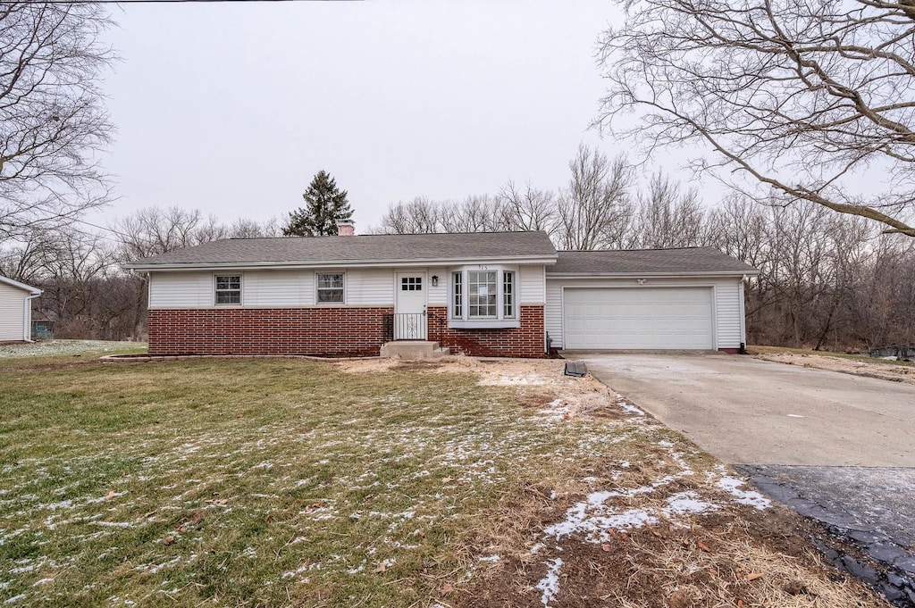 view of front of house with a front yard and a garage