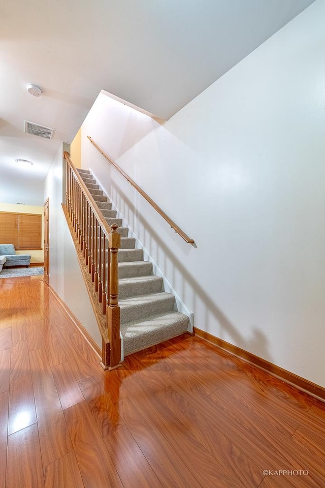 stairs with wood-type flooring