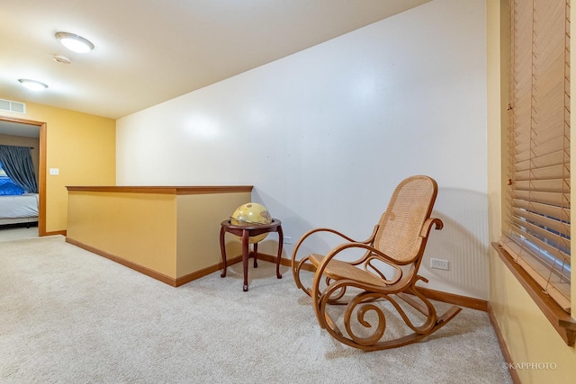 sitting room featuring light carpet