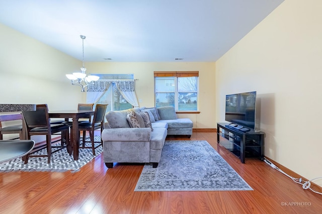 living room with a chandelier and wood-type flooring