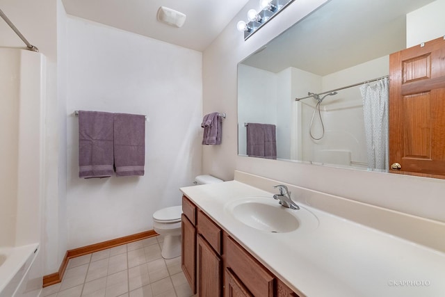 bathroom with toilet, vanity, and tile patterned floors