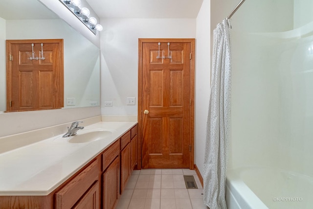 bathroom featuring tile patterned floors, vanity, and shower / bath combination with curtain