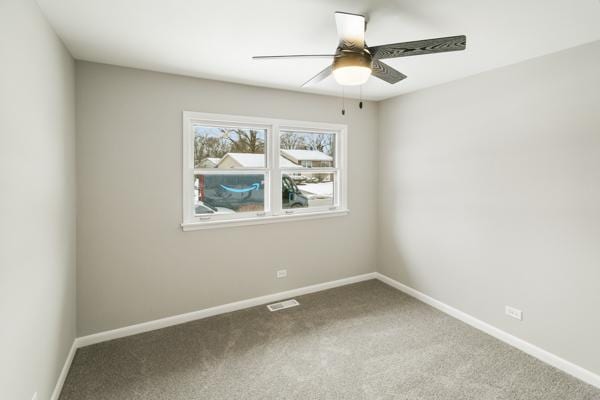 empty room with ceiling fan and carpet floors