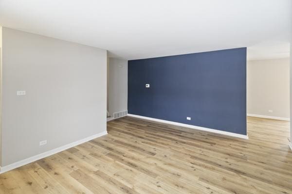 spare room with light hardwood / wood-style flooring