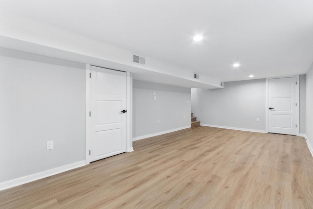 basement with light hardwood / wood-style flooring