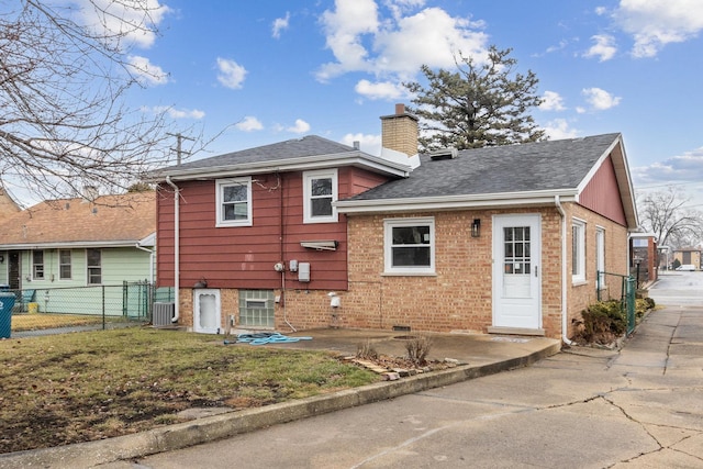 back of property with a yard and a patio