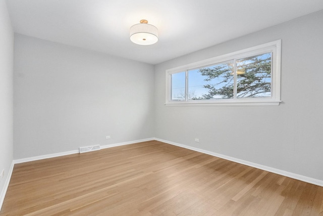 empty room featuring hardwood / wood-style floors and a wealth of natural light