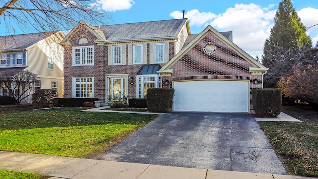 view of front of home featuring a front lawn and a garage