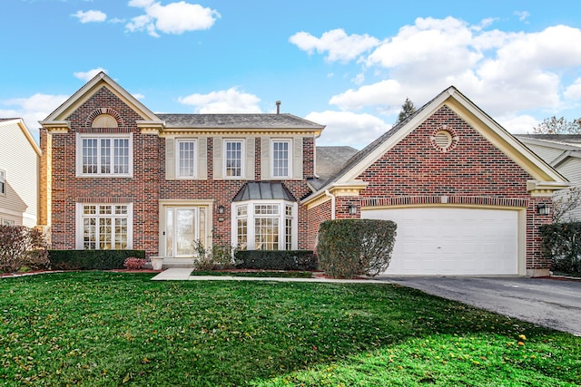 view of front of property with a garage and a front lawn