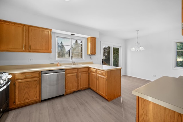 kitchen featuring sink, hanging light fixtures, stainless steel appliances, an inviting chandelier, and kitchen peninsula