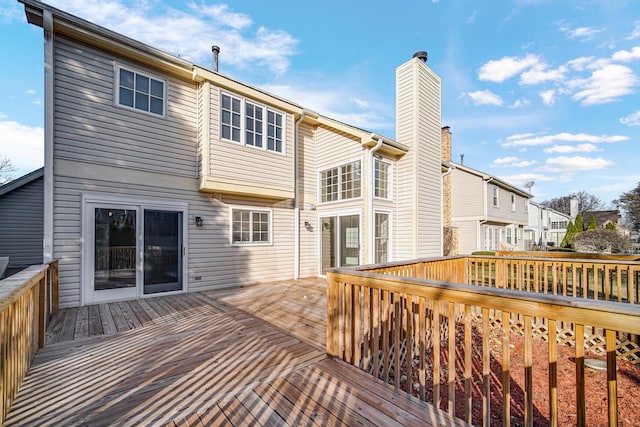 rear view of house featuring a wooden deck