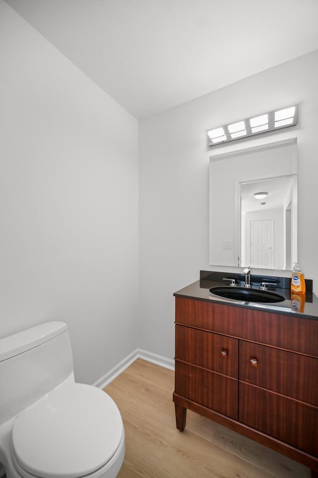 bathroom featuring hardwood / wood-style floors, vanity, and toilet