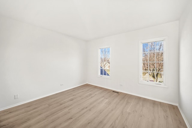 spare room featuring light wood-type flooring