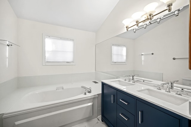 bathroom with a bathing tub, vanity, lofted ceiling, and toilet