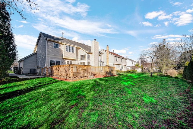 back of house featuring a lawn, a wooden deck, and cooling unit