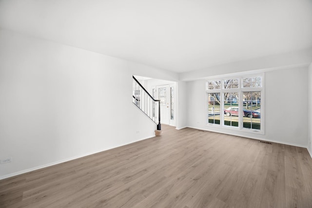 unfurnished living room with light wood-type flooring