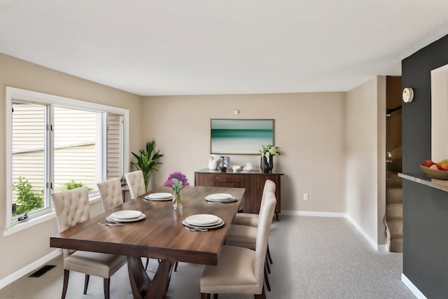 dining area featuring carpet flooring