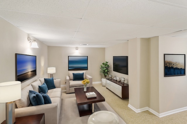 living room with a drop ceiling