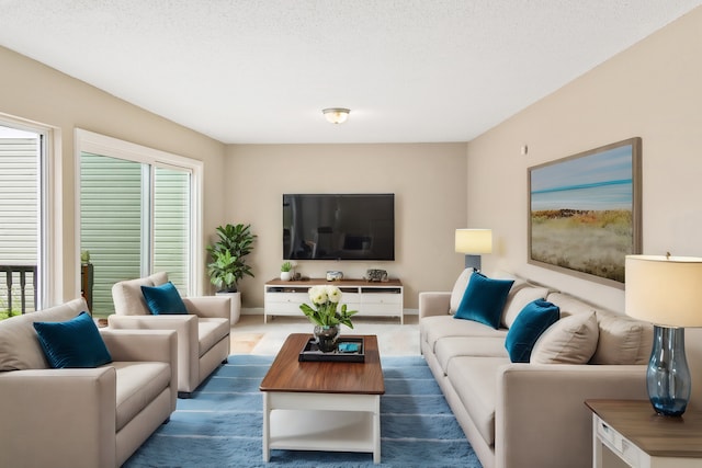 living room featuring a healthy amount of sunlight and a textured ceiling