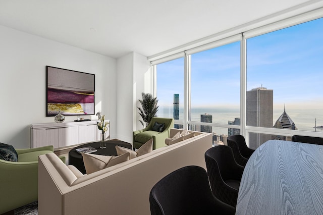 living room featuring floor to ceiling windows and a water view