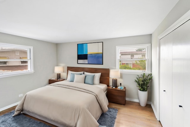 bedroom with a closet and light hardwood / wood-style floors