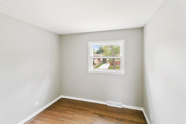 unfurnished room featuring hardwood / wood-style flooring