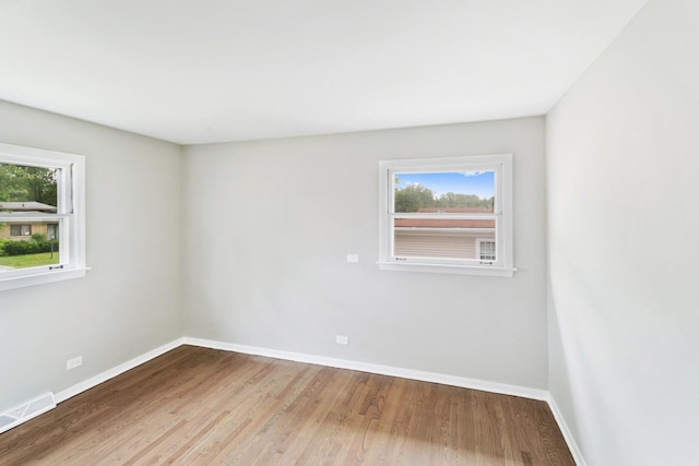 unfurnished room featuring hardwood / wood-style flooring