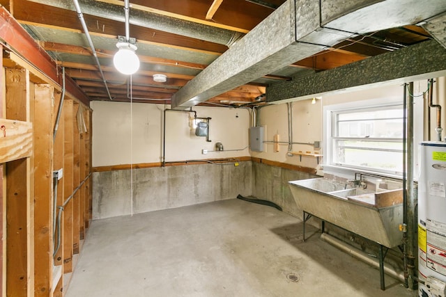 basement with gas water heater, sink, and electric panel