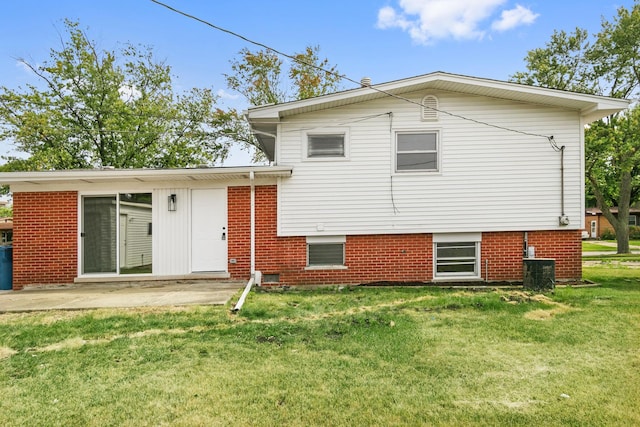 back of house featuring a patio area and a yard