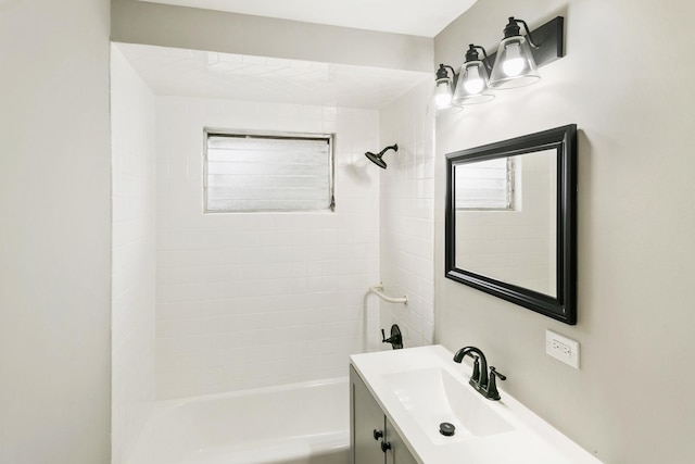 bathroom with vanity and tiled shower / bath combo