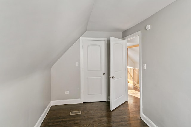 bonus room featuring dark hardwood / wood-style flooring and lofted ceiling