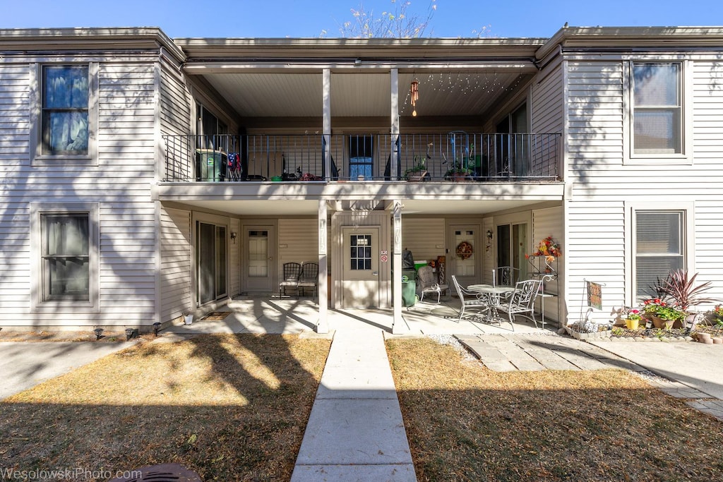 back of house featuring a balcony and a patio area