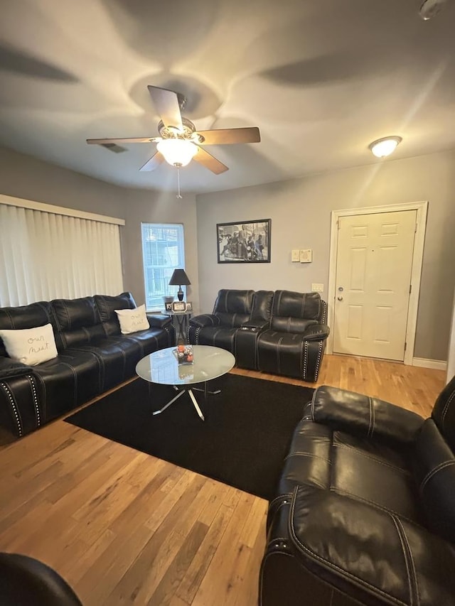 living room featuring hardwood / wood-style flooring and ceiling fan