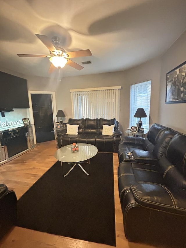 living room featuring hardwood / wood-style flooring and ceiling fan