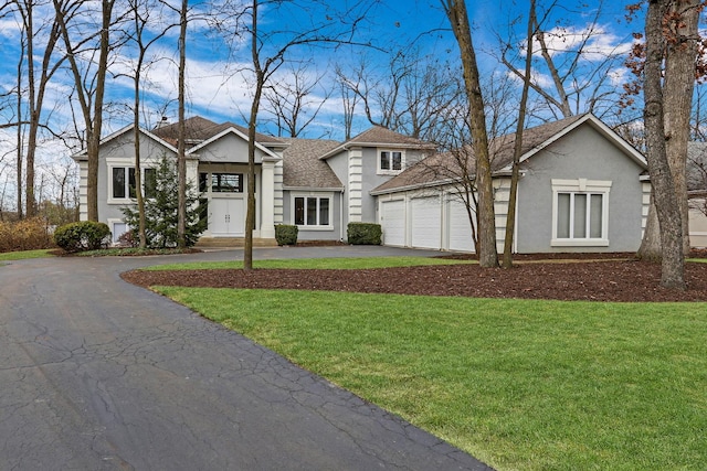 view of front of house with a front yard and a garage