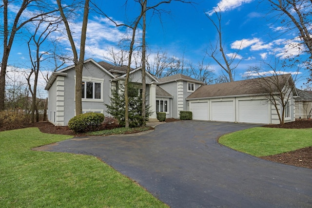 view of front of property featuring a garage and a front lawn