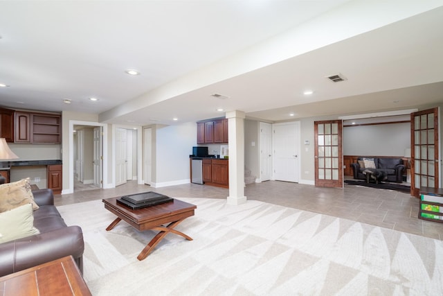 living room featuring french doors and light tile patterned floors