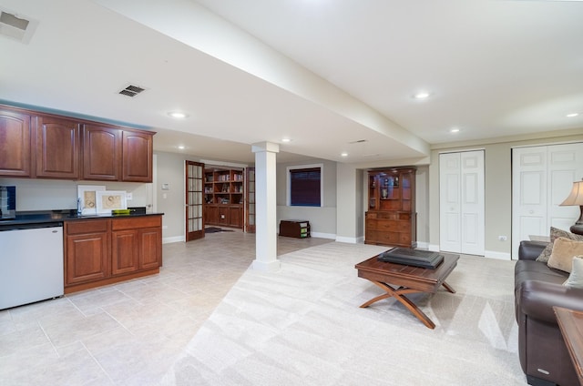 living room featuring ornate columns and sink