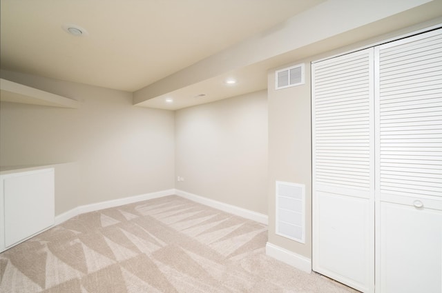 basement featuring light carpet