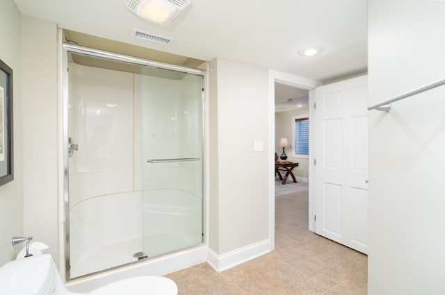 bathroom featuring an enclosed shower and toilet