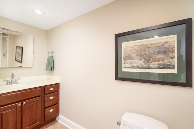 bathroom featuring tile patterned floors, vanity, and toilet