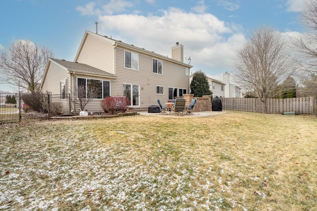 rear view of property featuring a yard and a patio area