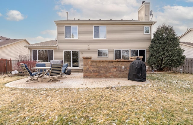 rear view of property with a yard and a patio