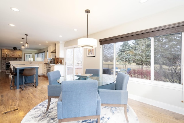 dining space with light hardwood / wood-style flooring and plenty of natural light